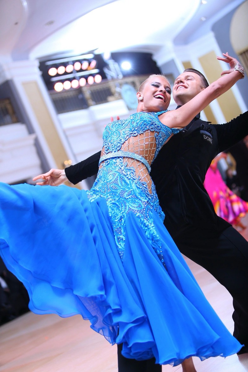 Slawek Roszak in a Standard dance pose with his partner in a blue gown