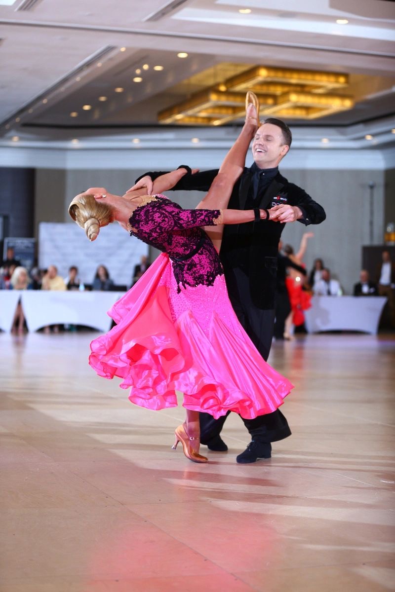 Slawek Roszak and his partner in a pink gown on the competition floor