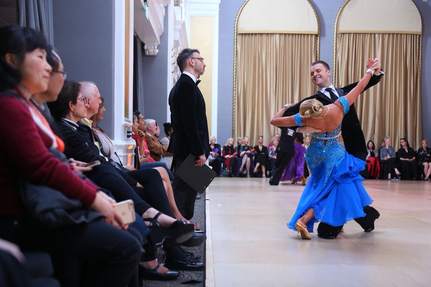 Slawek Roszak performing in a ballroom with spectators